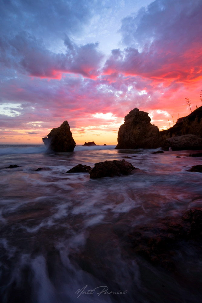 Malibu beach sunset along the Los Angeles coast at El Matador State Beach with dramatic sky explosion and ocean waves