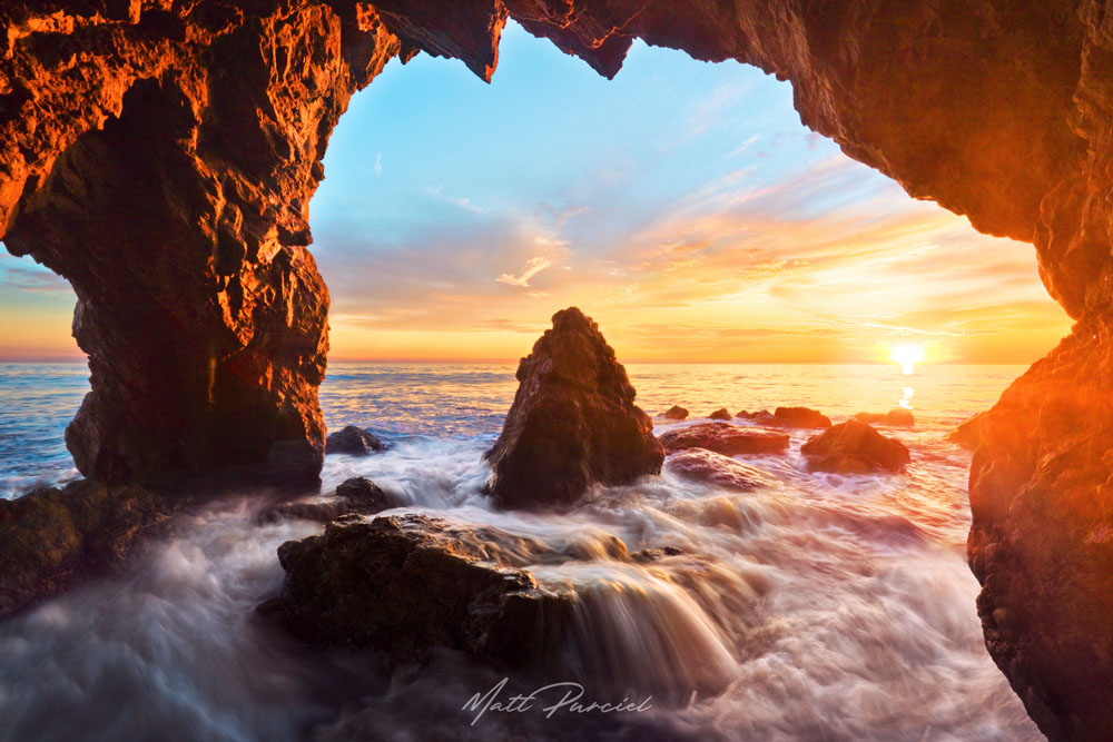 Malibu beach sunset along the Los Angeles coast at El Matador State Beach with dramatic sky explosion and ocean waves
